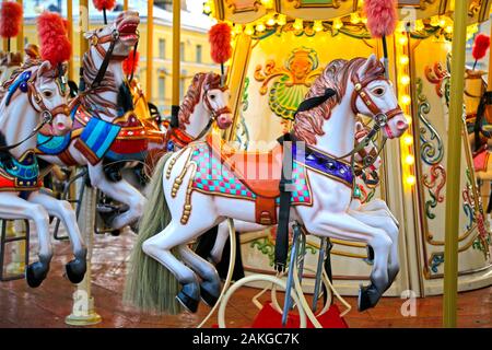 Colouful carousel horses on a traditional merry-go-round on Helsinki Christmas Market, Helsinki, Finland. December 2019. Stock Photo