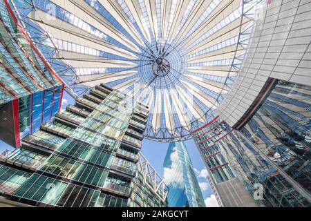 Wide angle view of the main hall of the Sony Center in Potsdamer Platz, with the flower-shaped roof standing against a summer blue sky Stock Photo