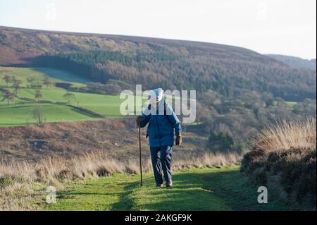 Elderly couple climbing Hawnby Hill, North Yorkshire, UK Stock Photo