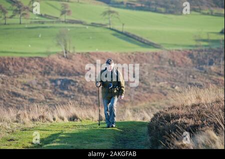 Elderly couple climbing Hawnby Hill, North Yorkshire, UK Stock Photo