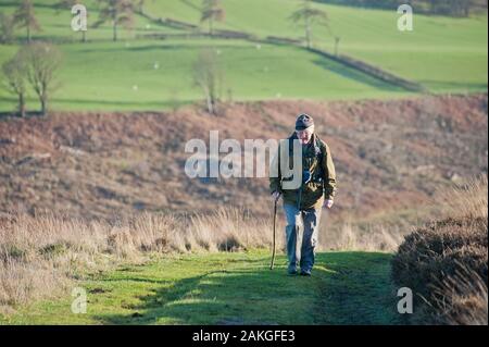 Elderly couple climbing Hawnby Hill, North Yorkshire, UK Stock Photo