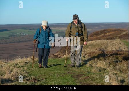 Elderly couple climbing Hawnby Hill, North Yorkshire, UK Stock Photo