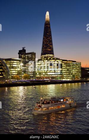 United Kingdom, London, Southwark district, London bridge quarter, boat on the river Thames in front of the More London Development and the Shard London Bridge Tower by architect Renzo Piano, the tallest tower in London Stock Photo