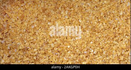 Brown sugar granules, background, close up Stock Photo