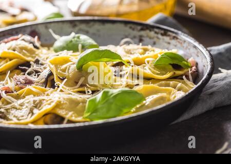 Pasta ravioli stuffed with spinach mustooms prosciutto basil and parmesan cheese Stock Photo