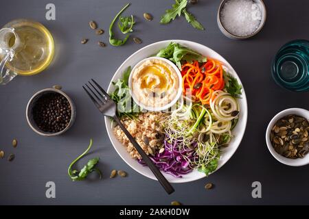 veggie couscous lunch bowl with spiralazed carrots and zucchini, hummus and red cabbage Stock Photo