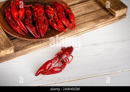 Delicacy food concept. Crayfish on a wooden tray. Selective focus, copy space Stock Photo