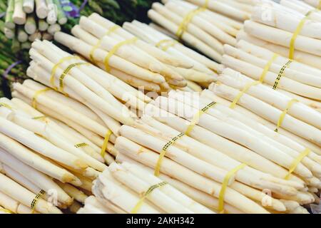 Bunches of fresh raw white organic asparagus vegetables for sale at farmers market.Vegan food and healthy nutrition. Stock photo white Asparagus as a Stock Photo