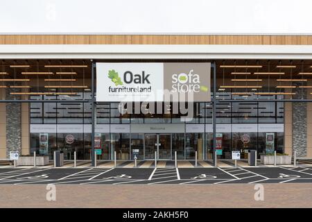 Rugby, Warwickshire, UK: Oak Furnitureland and Sofa Store outlet behind some disabled parking spaces on the Elliott's Field Retail Park. Stock Photo