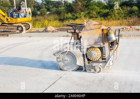The joint cutter machine on a brushed concrete surface. Construction equipment for cutting saw slab. Stock Photo
