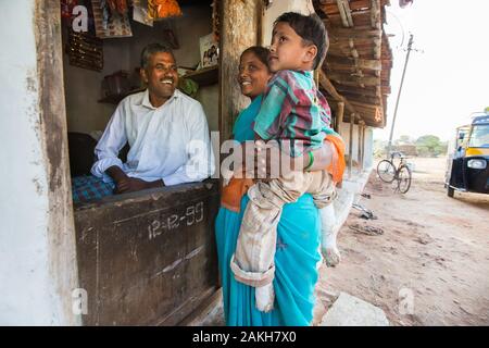 CAPTION: Using a loan from his local self-help group (SHG), Mariswamy has set up a petty shop to help cover the costs associated with his son Manu's c Stock Photo