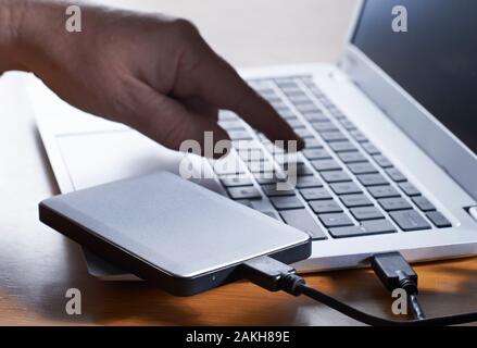 Data Being Illegally Downloaded From Computer Onto External Hard Drive Stock Photo