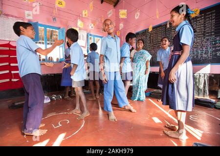 CAPTION: At the end of a classroom session, Hemavathi gets the children to do a group work exercise that reviews, in a fun way, what has been taught. Stock Photo