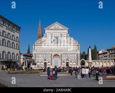 FLORENCE, ITALY, January 6, 2020: Tourists enjoying winter sun, out of season in Florence, Tuscany. In front of the cathedral, Duomo, aka Basilica di Stock Photo