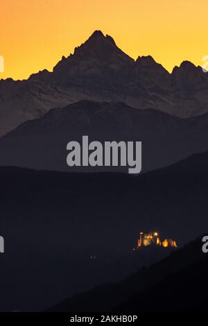 the Sacra di San Michele and Monviso: the two symbols of Piedmont aligned at sunset. Stock Photo