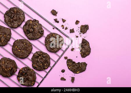 Homemade gluten-free chocolate chip cookies with cereals, nuts and organic cocoa. Cookies and pastries from rye flour on a colored background. Gluten Stock Photo