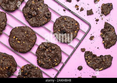 Homemade gluten-free chocolate chip cookies with cereals, nuts and organic cocoa. Cookies and pastries from rye flour on a colored background. Gluten Stock Photo