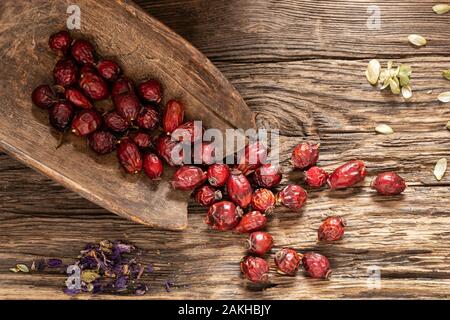 Dried rose hips on a rustic background, top view Stock Photo