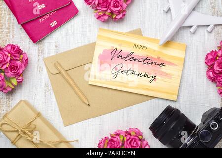 Mockup wooden card and envelop on grunge white wood for travel with valentines day & love season background concept. Top view of  rose flowers, craft Stock Photo
