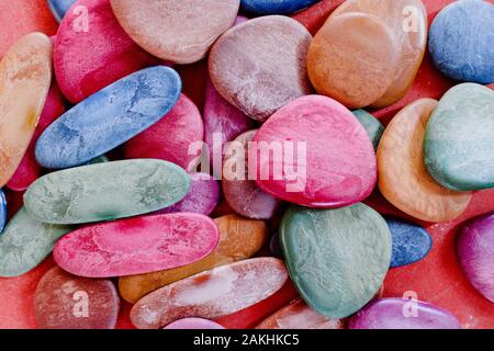 Colored plastic pebbles to play babies. Stock Photo