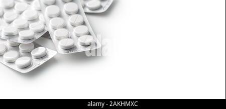 Heap of white medical pills in plastic package Stock Photo