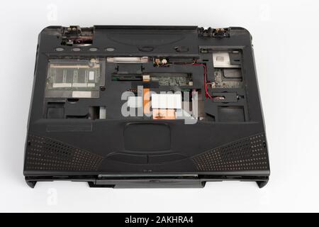 old laptop, removed monitor , keyboard, battery and  floppy disk drive on white background Stock Photo