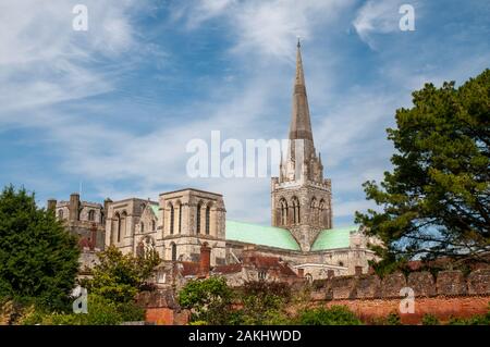 The cathedral of Chichester, West Sussex, seen from the Bishop's Palace Gardens separated by the red brick Tudor wall Stock Photo