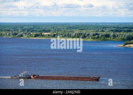 Barge on river sailing to port for cargo. Transport for transportation of crushed stone and sand Stock Photo