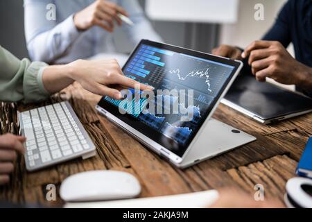 Close-up Of Male And Female Businesspeople In Meeting Discussing Graphs Stock Photo