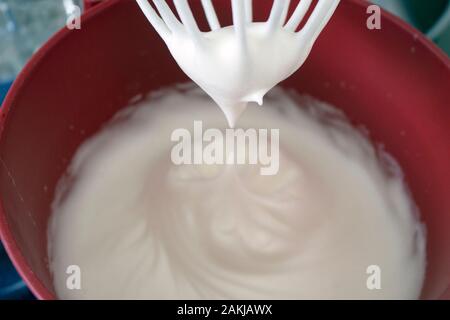 Egg whites beaten in snow, to become an ingredient in sweet and savory dishes Stock Photo