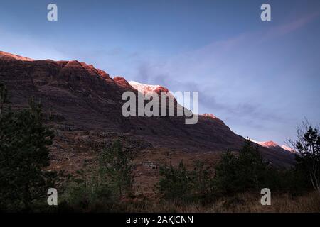 A full frame braketed hdr image of the winter sun setting on the Torridon mountains Liathach and Beinn Eighe, Wester Ross, Scotland. 26 December 2019 Stock Photo