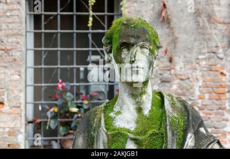 Stone statue covered in moss in the courtyard of Territorio palace in Vicenza, Italy Stock Photo