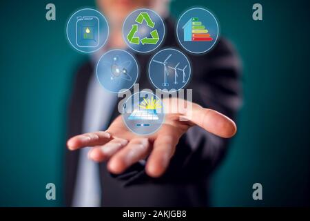 Businessman in suit with virtual save energy buttons. Alternative energy and environmental protection concept Stock Photo