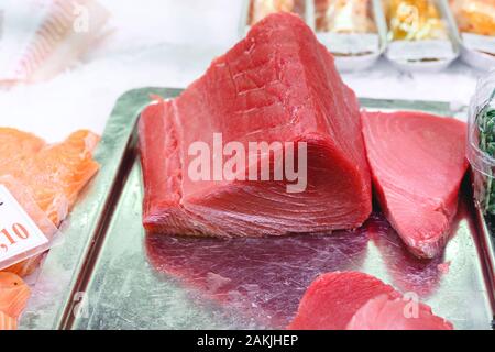 Raw Tuna Fish fillet for sashimi or steak at the fish market. Large assortment of fresh seafood and Tuna fillet. Keto food and healthy nutrition Stock Photo