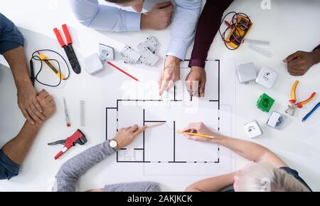 Elevated View Of An Architects Drawing Plan On Blueprint With Electrical Components Stock Photo