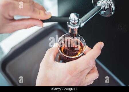 Caucasian man pouring traditional Turkish tea from teapot Stock Photo