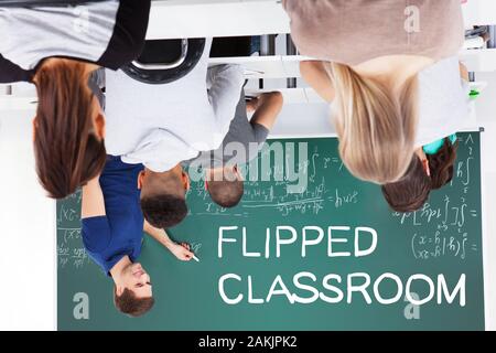 Young College Students Sitting In Flipped Classroom Stock Photo