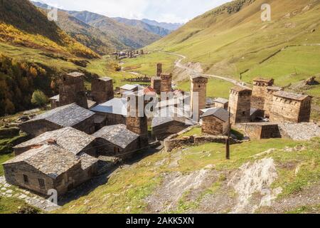 View of Ushguli village in Enguri River valley. Ancient Svan towers on background of beautiful mountain landscape. Caucasus traver. Georgia, Upper Sva Stock Photo