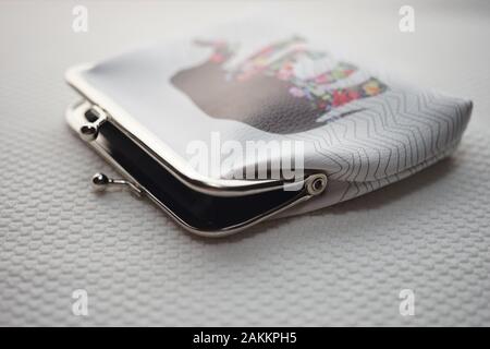 Purse for coins. Wallet for change. Leather purse closeup on a white table. Stock Photo