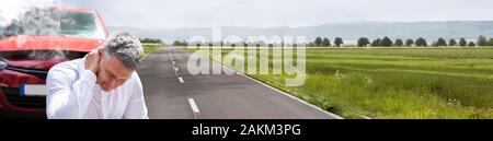 Close-up Of A Mature Man Suffering From Neck Pain In Front Of Breakdown Car Stock Photo