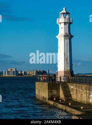 Lighthouse on harbour wall with blue sky, Firth of Forth, Newhaven Harbour, Edinburgh, Scotland, UK Stock Photo