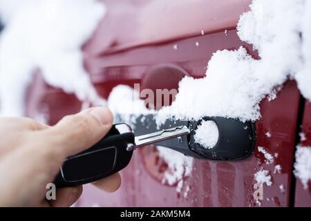 Man Trying To Open Frozen Car Door With Key Stock Photo