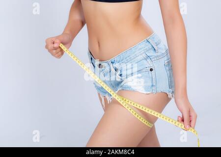 Woman with measuring tape. Weight loss concept. Woman take waist scale tape  show her thin waist. Slim girl with centimeter. Closeup woman measuring  Stock Photo - Alamy