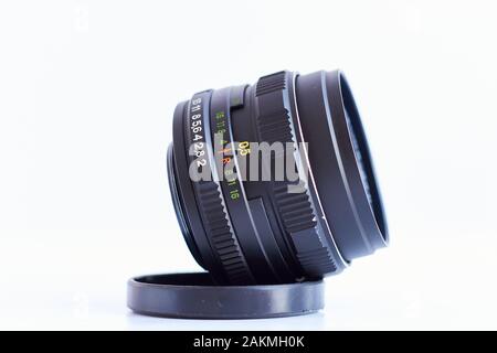 Old Russian Zenith vintage 58mm fixed lens isolated with white background, focus on aperture ring. Stock Photo