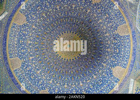 Isfahan, Iran - May 2018: Breathtaking ceiling decorated with colorful tiles in interior of Imam Mosque at Naghsh-e Jahan Square Stock Photo