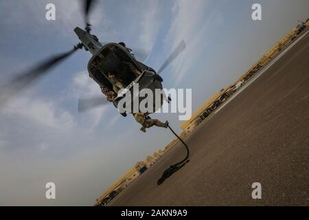 A Soldier from the 5th Special Forces Group (Airborne) exits an MH-60 ...