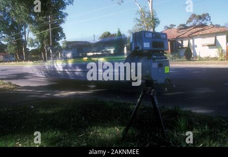 POLICE SPEED CAMERA MOUNTED ON TRIPOD IN OPERATION ON A SUBURBAN SYDNEY ROAD, NEW SOUTH WALES, AUSTRALIA. Stock Photo