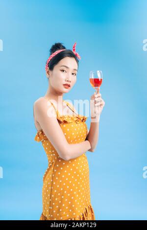 Portrait of a smiling young woman holding a glass of red wine Stock Photo