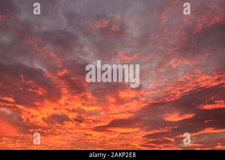 dramatic cloudy sky in the rays of setting sun. Stock Photo