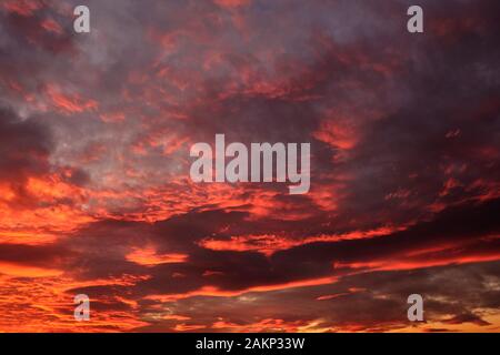 dramatic cloudy sky in the rays of setting sun. Stock Photo
